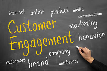 gentleman writing "customer engagement" and other key factors on a chalk board