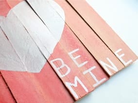 Be mine with a heart drawn on a wooden pallet
