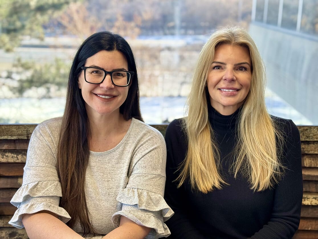 two ladies smiling for portrait