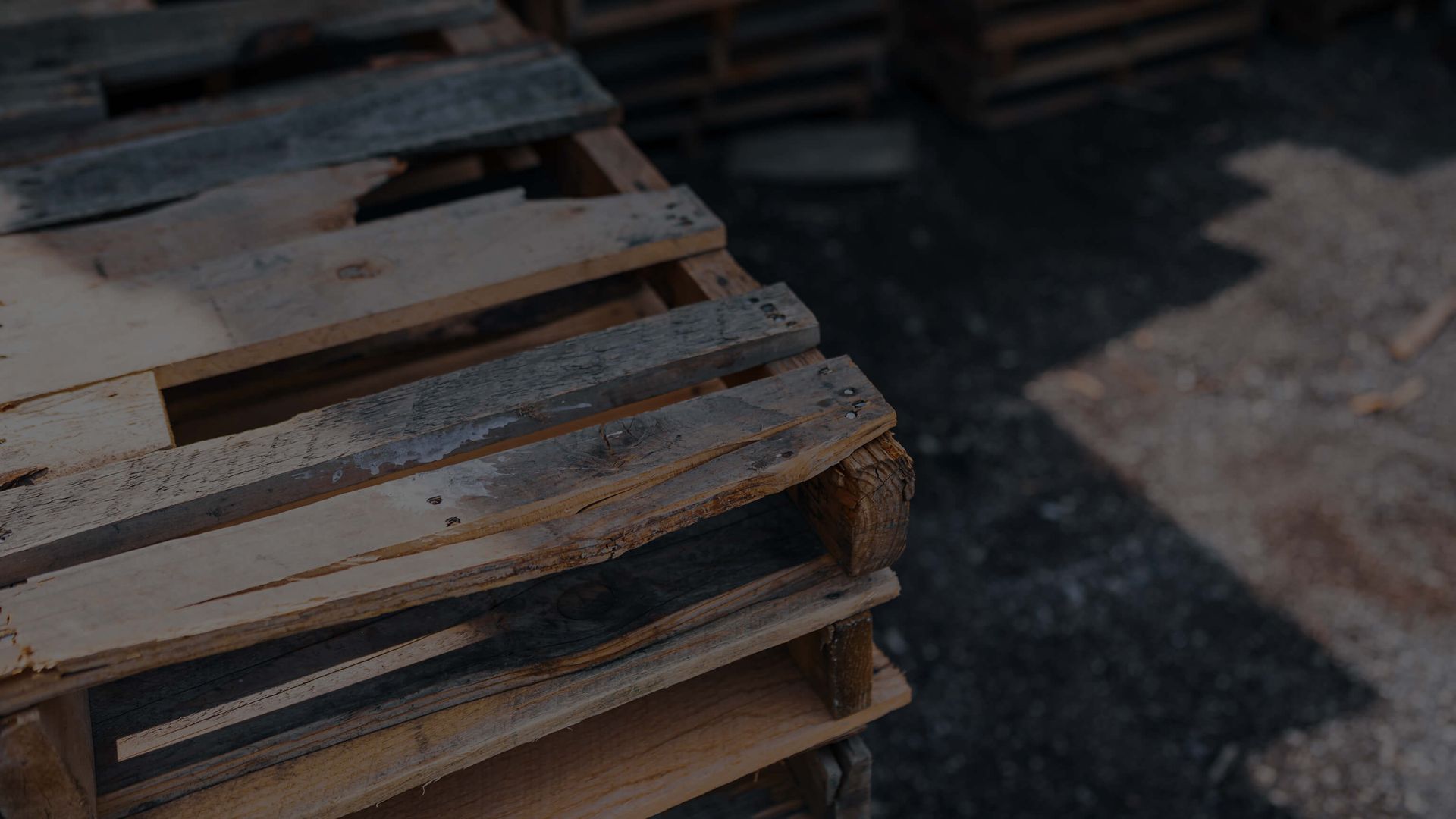 close-up of damaged pallet with dark overlay