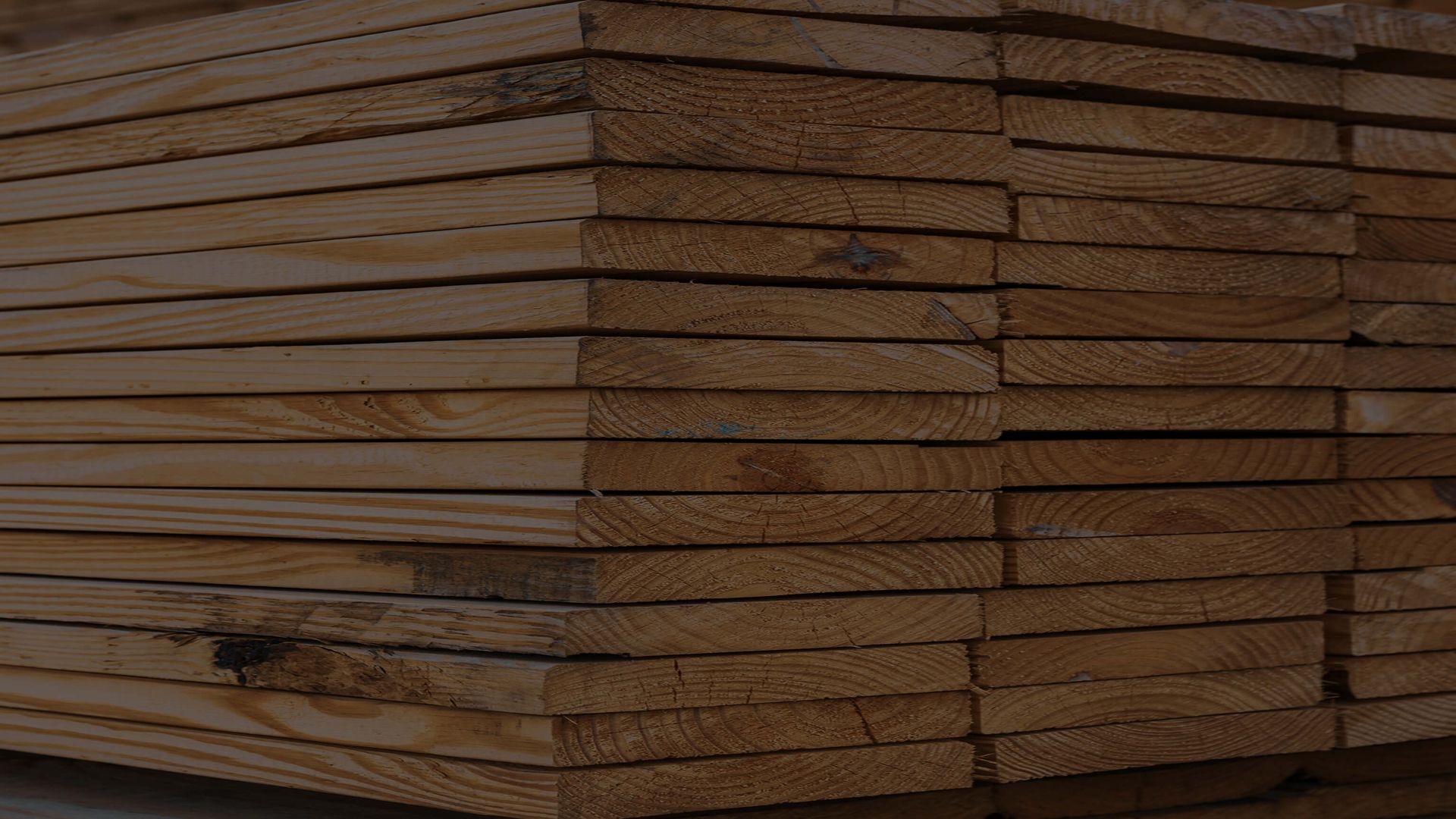 piles of lumber with dark overlay