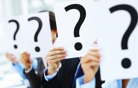 people holding up question marks