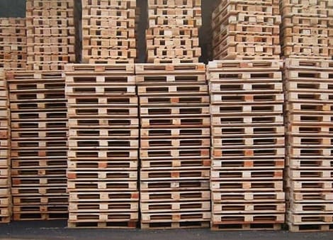 hundreds of wooden pallets stacked up