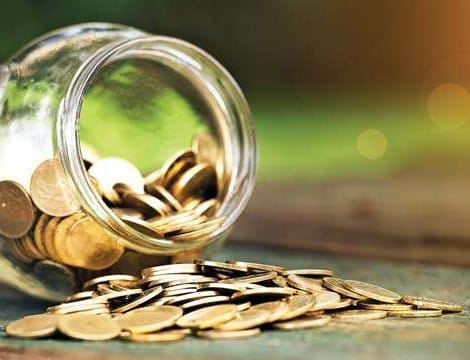glass jar with change spilled over