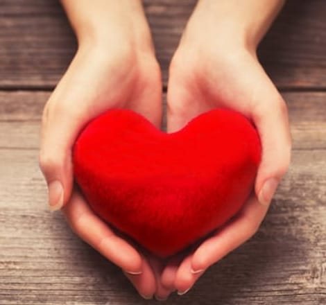 woman holding heart in hand