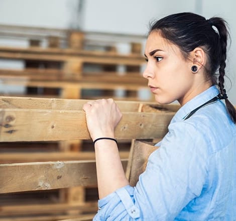 woman holding wooden pallet