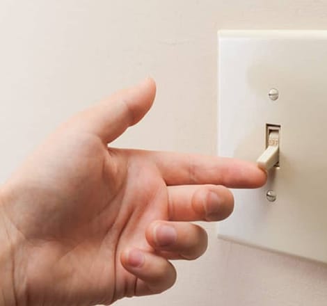 someone turning on the light switch