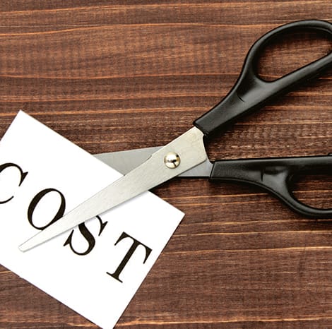 scissors cutting a paper that says "cost"