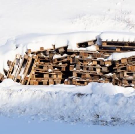 wooden pallets covered in snow