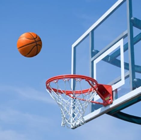 close-up of a basketball going into the hoop