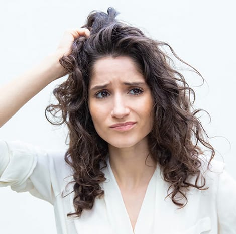 woman scratching her head