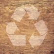 recycle sign with wooden background