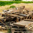 broken pallets and unwanted pallets stacked in a pile ready for trash