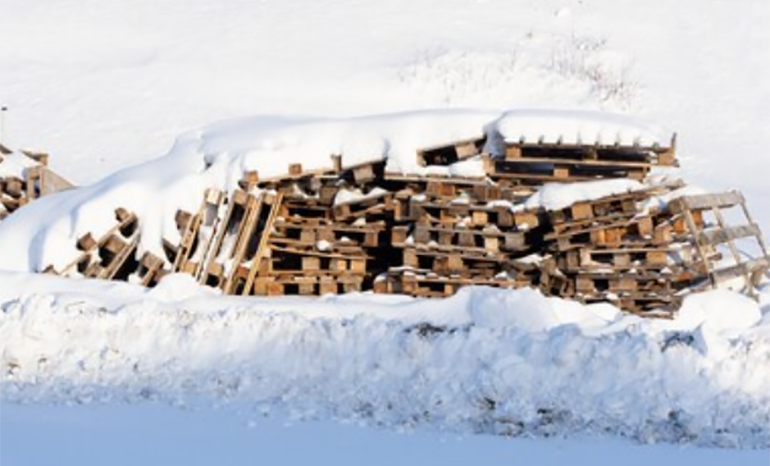 wooden pallets covered in snow