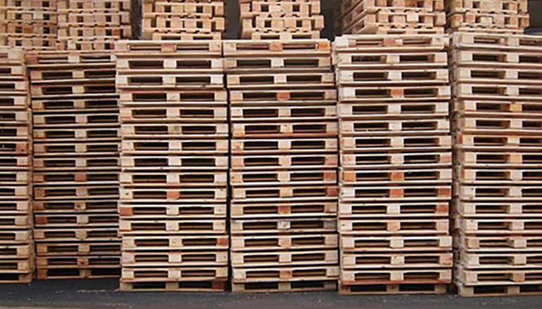 multiple wooden pallets piled up