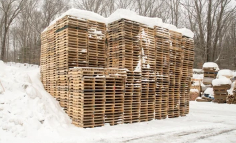 Multiple pallets covered in snow
