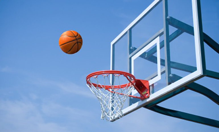 close-up of a basketball going into the hoop